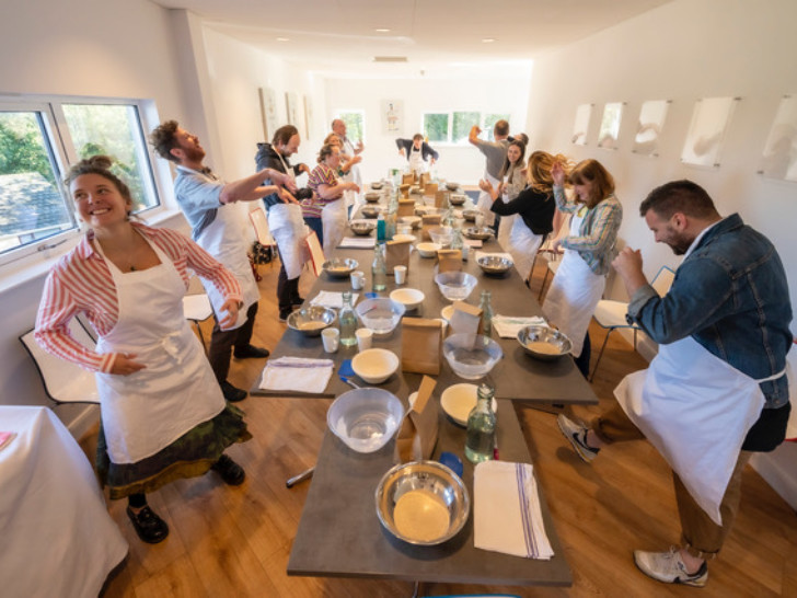 Photo of a group of people wearing white aprons