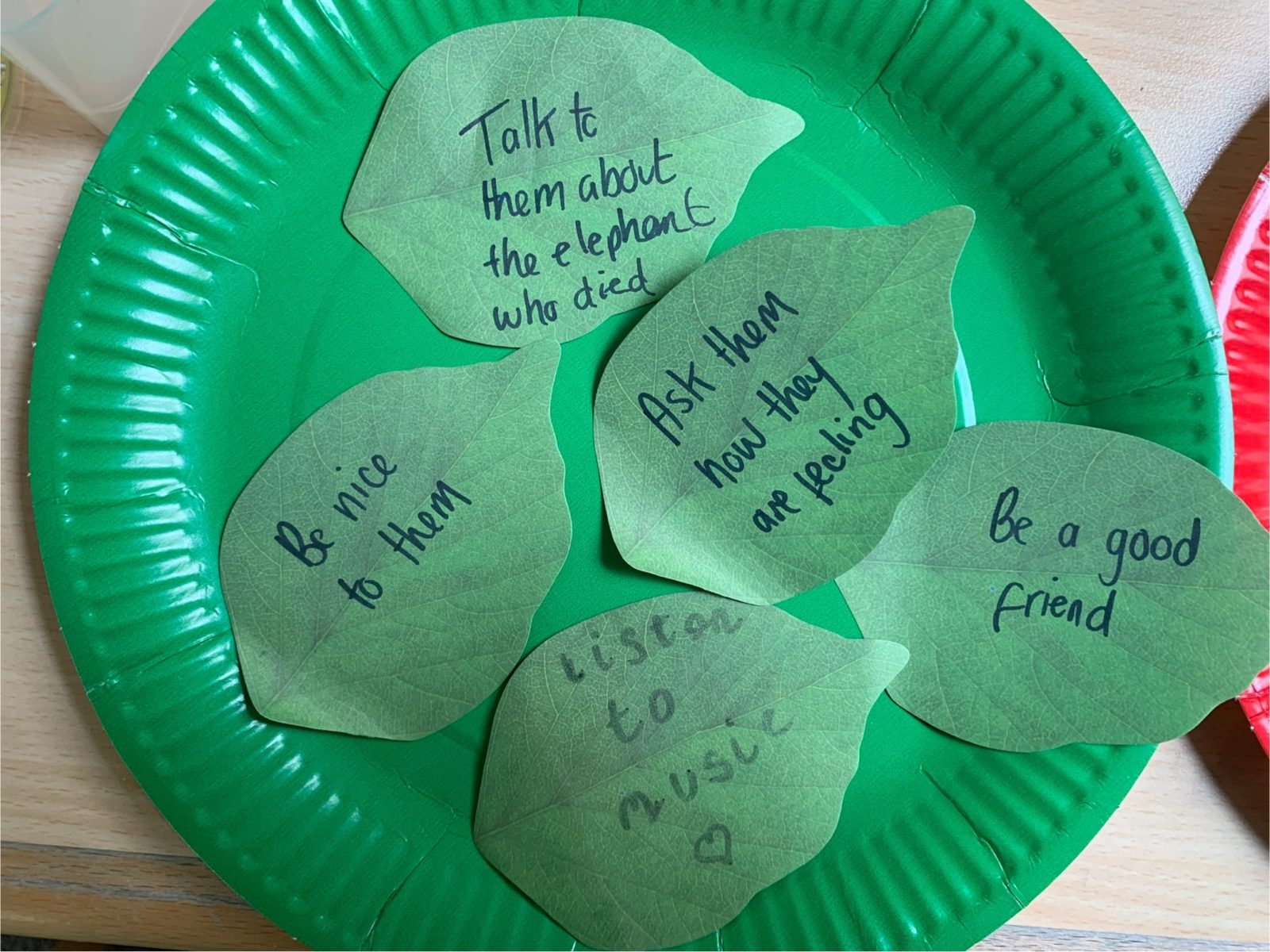 A collection of green post its with suggestions for support including "be a good friend" and "listen to music"